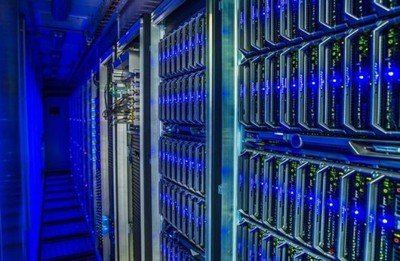 Workers inspecting mining rigs in a large mining farm