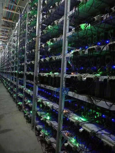 A large-scale mining farm with rows of mining machines.